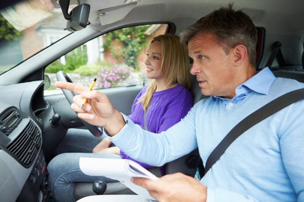 Driving instructor reviewing progress with a learner to work out how many driving lessons you need